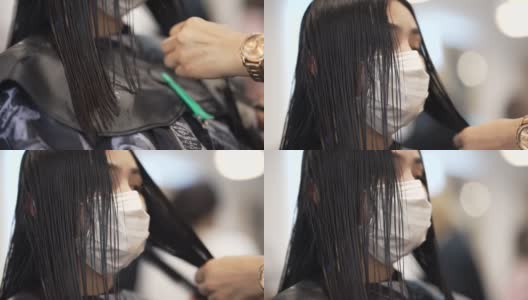 一个亚洲女人，她在美容院穿着护身衣，她卷头发，拉直头发。高清在线视频素材下载