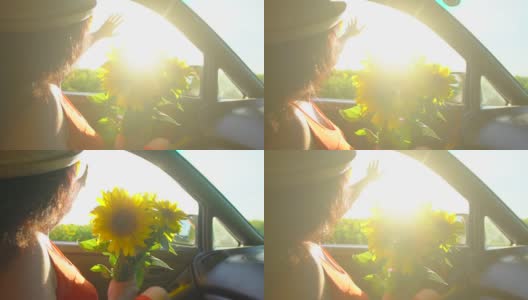 快乐的年轻旅行年轻女子享受公路旅行在夏天的自然与向日葵束。女孩挽着胳膊，把她的手伸出车窗，乘汽车旅行快乐的假期暑假高清在线视频素材下载