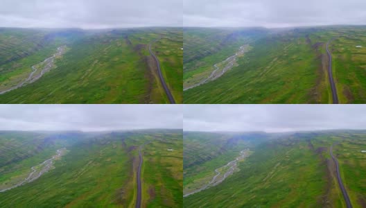 鸟瞰图美丽的道路通过一个美丽的乡村在西峡湾，冰岛高清在线视频素材下载