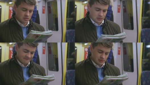 在地铁上看报纸的通勤者高清在线视频素材下载