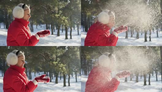 冬姑娘在红彤彤的雪中吹着手心，在温暖的夕阳下高清在线视频素材下载