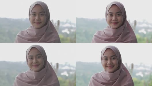 美丽的东南亚穆斯林妇女的肖像与头巾微笑在相机编辑和raw高清在线视频素材下载
