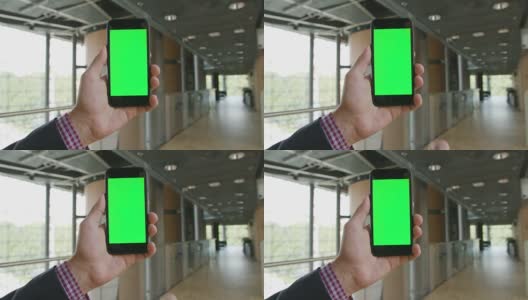 一只手拿着绿色屏幕的手机高清在线视频素材下载