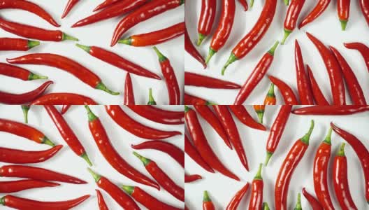 在白色背景上旋转自然成熟的红辣椒，俯视图，4K高清在线视频素材下载