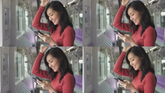 一名亚洲女性在火车上使用智能手机高清在线视频素材下载