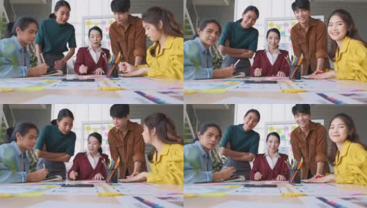 亚洲女性领导者建议ux/ui设计师关于在桌子上和在现代办公室看着摄像头的移动应用界面线框设计。创意数字发展机构高清在线视频素材下载