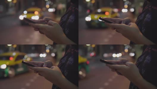 亚洲女性用智能手机在路边叫出租车。高清在线视频素材下载