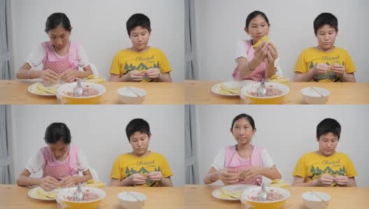 快乐亚洲小朋友在家一起包饺子，生活理念。高清在线视频素材下载