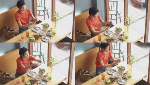 一名女博主在餐馆拍摄食物高清在线视频素材下载