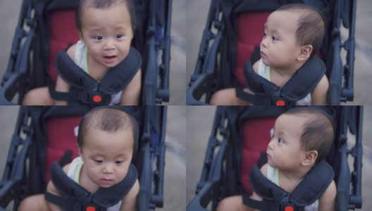 婴儿车上的亚洲男婴。高清在线视频素材下载