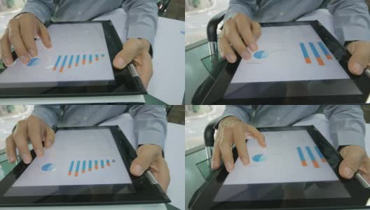 商人检查和分析数字平板电脑上的图表，摄影车从右向左拍摄高清在线视频素材下载