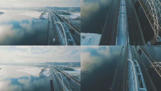 汽车和火车在结冰的河流上的一座桥上移动高清在线视频素材下载