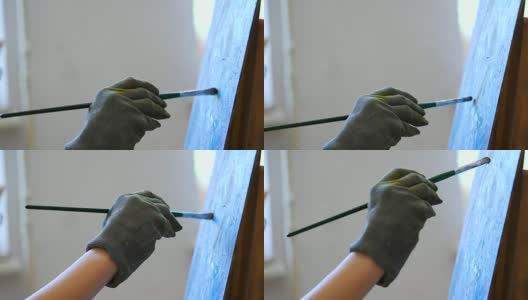 手的女艺术家在手套画画与油画颜料。在工作室工作的天才女孩的过程。4 k高清在线视频素材下载