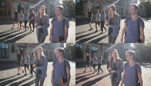 两个快乐的学生走在大学校园里高清在线视频素材下载
