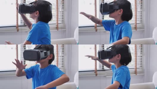 戴着虚拟现实眼镜的男孩。儿童体验虚拟现实。惊讶的小男孩看着VR眼镜。教育、儿童、技术、科学和人的观念高清在线视频素材下载