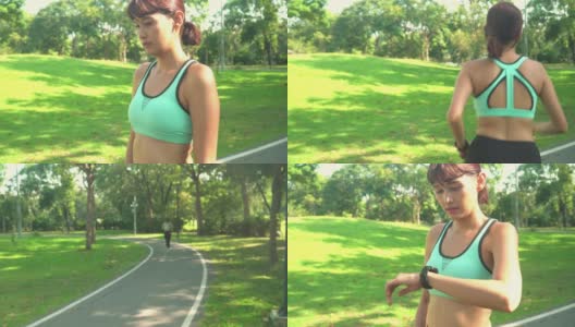 快乐的亚洲女运动员穿着运动服在户外的公园里沿着马路跑步，通过在智能手表上设置运动训练，准备带着快乐和成功的感觉跑步。走吧，女性力量的运动训练。高清在线视频素材下载