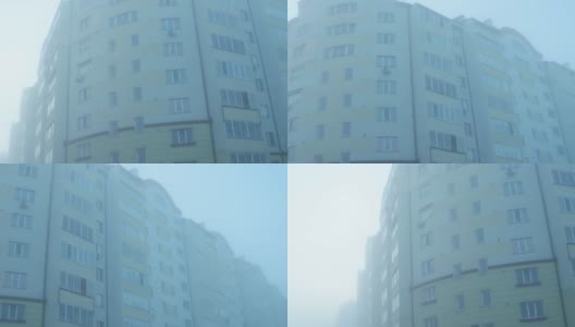 多层住宅楼在浓重的晨雾中，背景高清在线视频素材下载