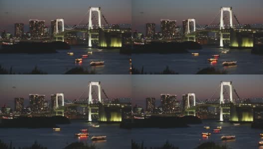 描述日落时分的东京全景天际线，彩虹桥和一些船只漂浮在东京湾上高清在线视频素材下载