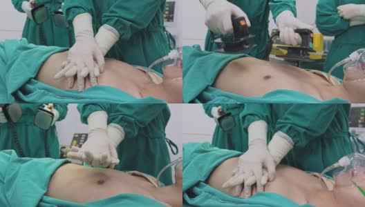 医院手术室的一组医生。亚洲专业的外科医生和护士团队为重症监护患者实施心肺复苏术，并在手术中使用除颤器电击心脏。高清在线视频素材下载