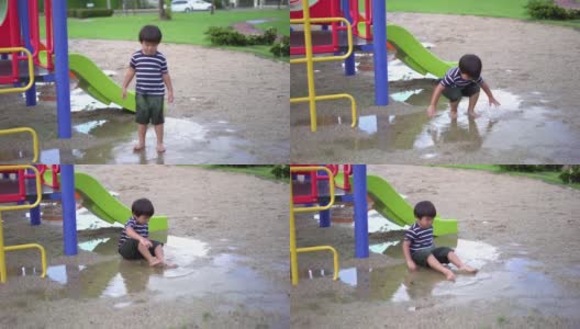 操场上，雨后坐在水坑里的可爱男孩高清在线视频素材下载