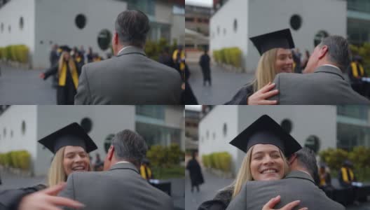 毕业典礼结束后，年轻漂亮的毕业生跑向她的爸爸，非常兴奋地拥抱他高清在线视频素材下载