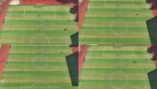 人们在足球场踢足球的无人机鸟瞰图高清在线视频素材下载