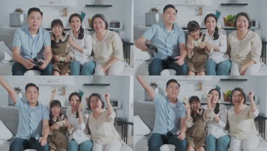 亚洲父亲和女儿与家人一起在家里的客厅玩主机游戏。妈妈和奶奶坐在他们旁边欢呼爸爸和孩子感到兴奋和有趣的笑容高清在线视频素材下载