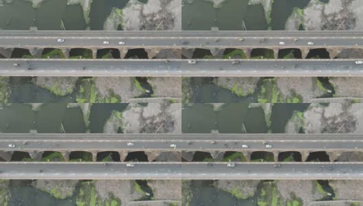 汽车行驶到桥向城市天际线，空中鸟瞰倾斜高清在线视频素材下载