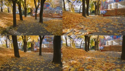 空荡荡的人行道上的城市游乐场在秋天，落叶枯黄高清在线视频素材下载