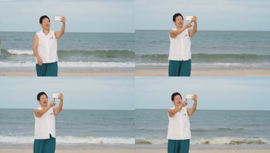 亚洲资深女性放松和谈论自拍在海洋海滩高清在线视频素材下载