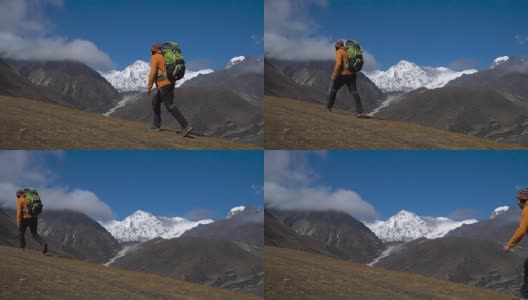 一个背着背包的男人爬上了喜马拉雅山的山坡高清在线视频素材下载