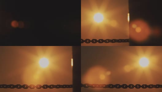 黑色的铁链在橘色夕阳下伸展，镜头光晕高清在线视频素材下载