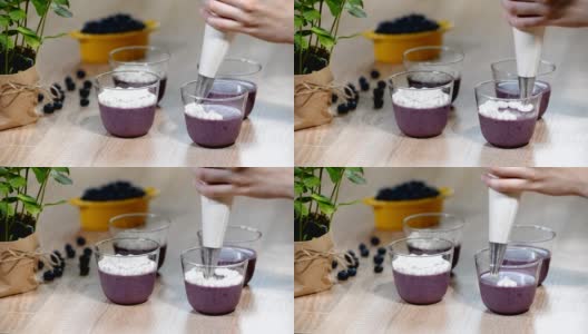 用玻璃杯装饰蓝莓意式奶冻。高清在线视频素材下载