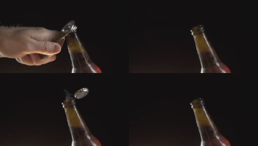 一只手打开一瓶啤酒的特写慢动作高清在线视频素材下载