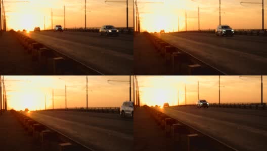 高速公路立交桥的慢镜头模糊了橙色的夕阳背景。高清在线视频素材下载