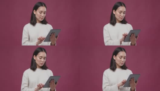 年轻的亚洲快活女人滚动平板电脑对抗马萨拉copyspace高清在线视频素材下载