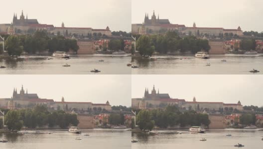 夜晚标志性的布拉格城堡和伏尔塔瓦河。人们享受着水上活动，并在河上游船经过高清在线视频素材下载