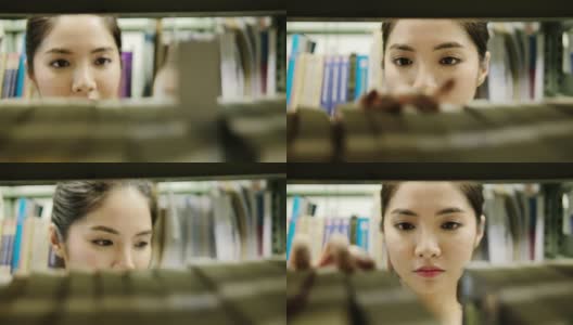 亚洲学生在图书馆看书。高清在线视频素材下载