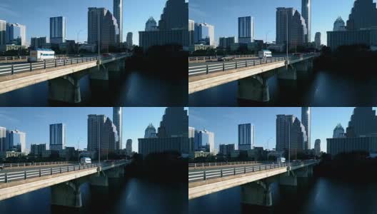 德克萨斯州奥斯汀阳光早晨食品卡车行驶在国会大道大桥前ATX天际线高清在线视频素材下载