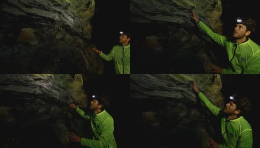 男性徒步旅行者探索黑暗的洞穴，4k高清在线视频素材下载