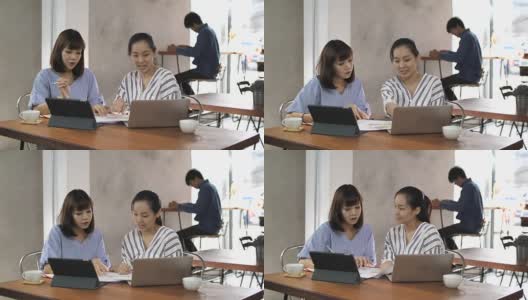 两个亚洲商人一起在咖啡馆工作，慢镜头高清在线视频素材下载