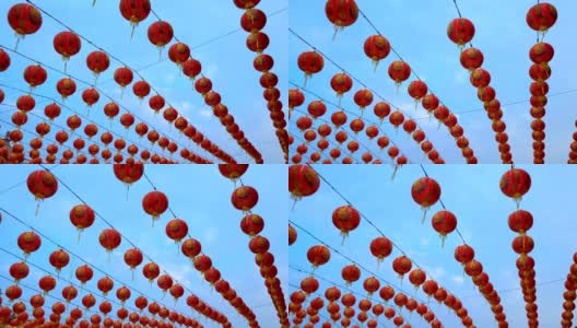 许多秋千中国灯笼装饰中国新年与蓝天背景。彩灯上的祝福文字寓意拥有财富和幸福高清在线视频素材下载