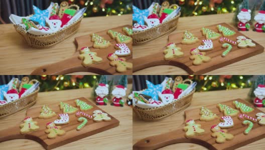 在摄影小车上可以看到:自制的糖衣圣诞饼干，红鞋，雪人，姜饼，圣诞树。有些饼干放在木盘子里，有些放在木架子上。黄色圣诞灯，圣诞装饰树和装饰品。高清在线视频素材下载