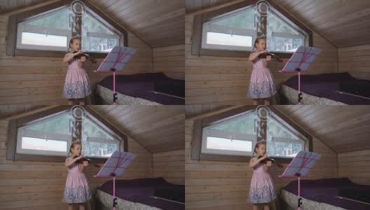 小女孩在阁楼上拉小提琴高清在线视频素材下载