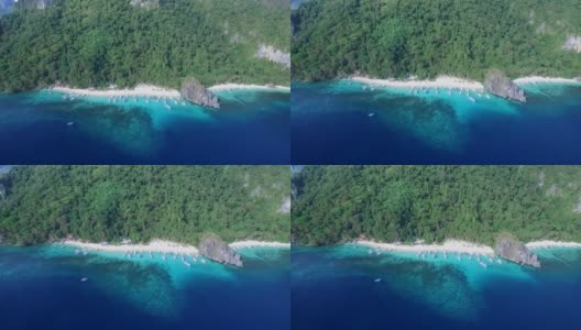 7名突击队员和木瓜海滩在巴拉望，观光地点。在菲律宾的埃尔尼多巡回演出。宁静的白色沙滩与清澈的绿松石水，棕榈树的岩石构成的背景高清在线视频素材下载