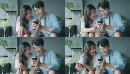 快乐的年轻夫妇看着手机高清在线视频素材下载