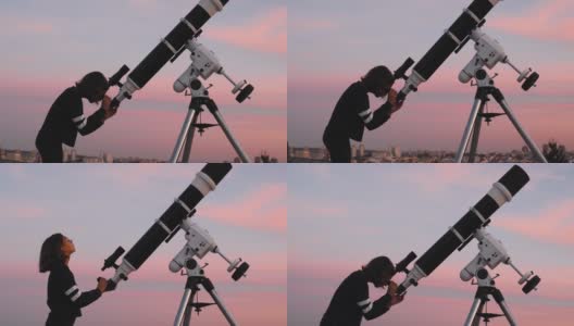一个小女孩的剪影，望远镜在繁星点点的天空下。高清在线视频素材下载