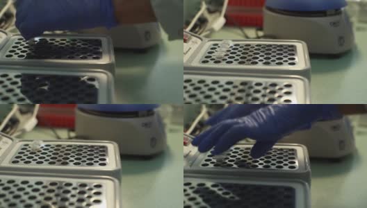 戴着医用手套、无法辨认的实验室技术人员的近距离双手将装有样本的试管放入用于DNA检测的设备中，COVID-19。高清在线视频素材下载