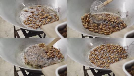 红色的蠕虫棕榈象鼻虫或西米甲虫在平底锅中油炸，西米虫在沸腾的油中油炸的特写高清在线视频素材下载