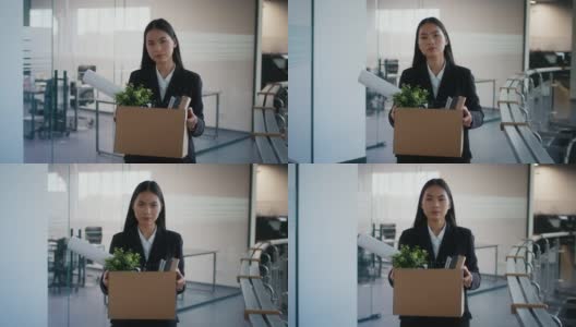 被解雇的亚洲妇女扛着箱子离开室内解雇后的工作场所高清在线视频素材下载